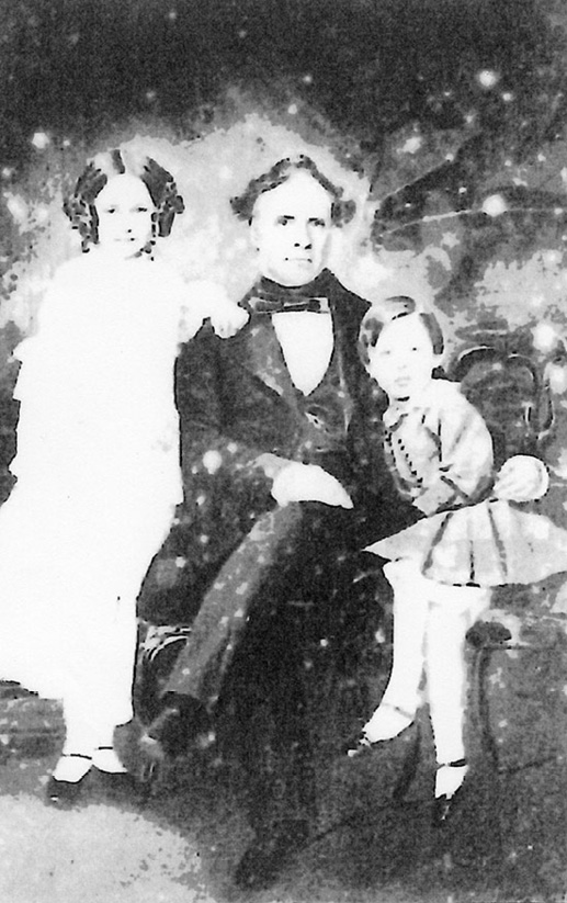 A very poor-quality image of Archibald Mirrielees with his children Maggie and Fred