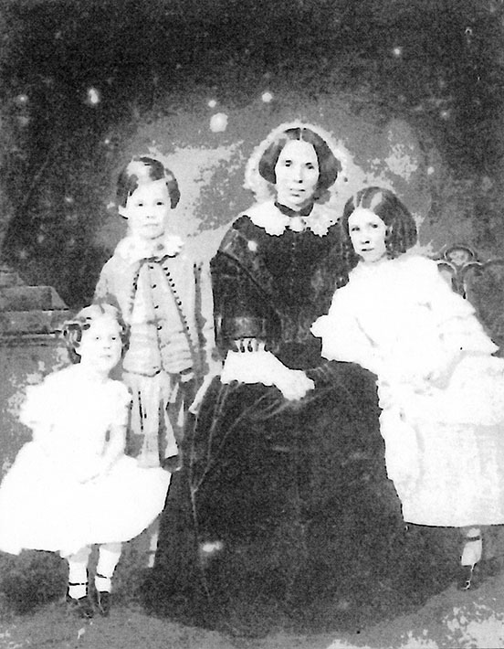 A very poor-quality image of Jane Muir Mirrielees and three of her children: Maida, Archy, and Augusta