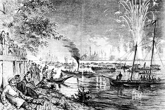 Fireworks upper right; spectators standing on the embankment and lying on the shore, front left; boats on the water illuminated by the fireworks