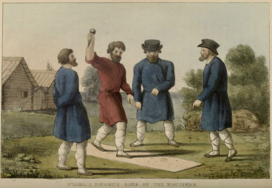 one man in red throwing down a spike towards a ring on a strip of dirt in the grass; three men in blue watch; all have white leggings bound with crossed laces