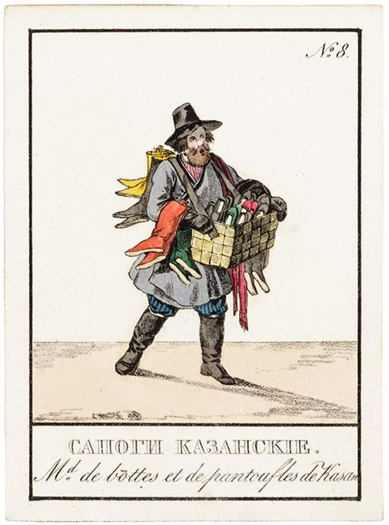 She salesman with a basket of colourful shoes, and boots draped over his arms and back