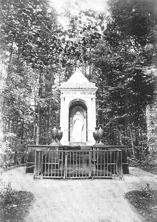 Twentieth century photograph of the monument built in memory of Grand Duchess Aleksandra Nikolaevna; a metal barrier surrounds the monument