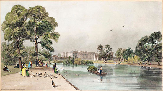 Buckingham Palace, with people on the shores of the lake in Saint James’s Park in foreground and a boat on the water