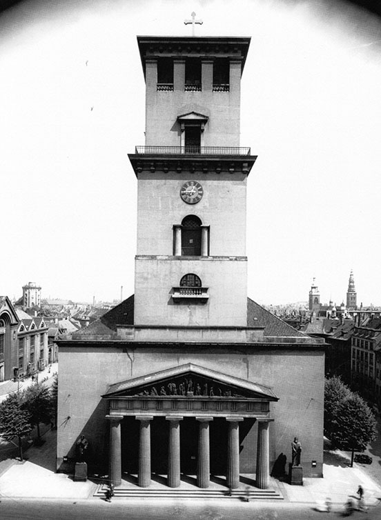 church with single square spire and front porch with six columns supporting a classical pediment