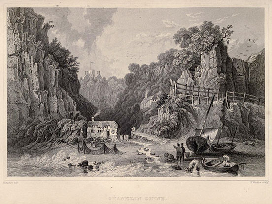 tall cliff on the left; lower cliff with a path and fence part way up on the right; building nestled between on the valley floor, beside a creek running down to the shore,; boat heaved over on its hull and a rowboat next to it in the water