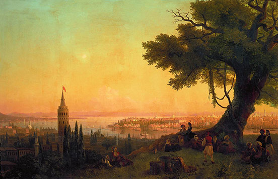 Orange and yellow and green sunrise; large tree on right on hillside with many people in shadow beneath it; spire in city below the hill on left