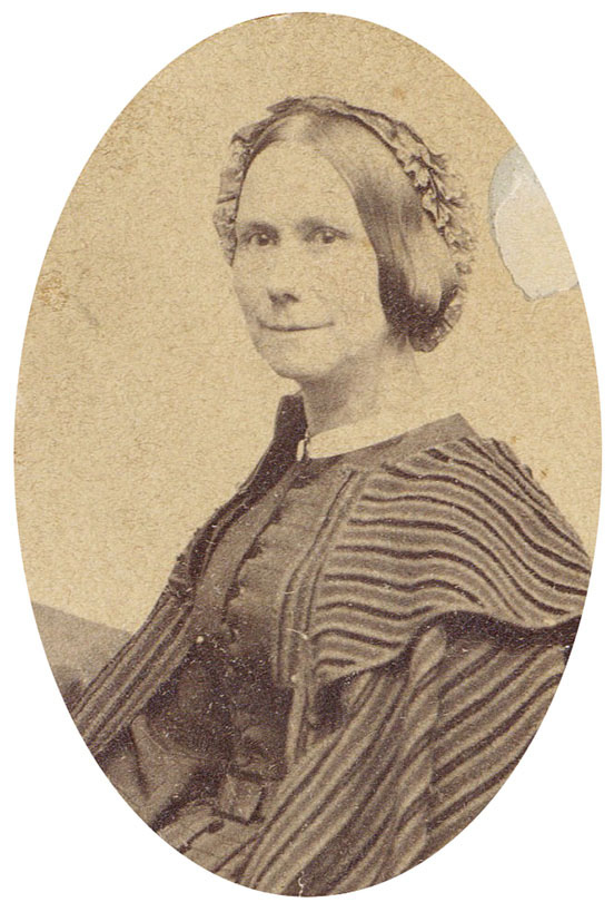 Photograph of Lydia Mason Morton Lee, circa 1880, in a striped dress, with a ruffled cap