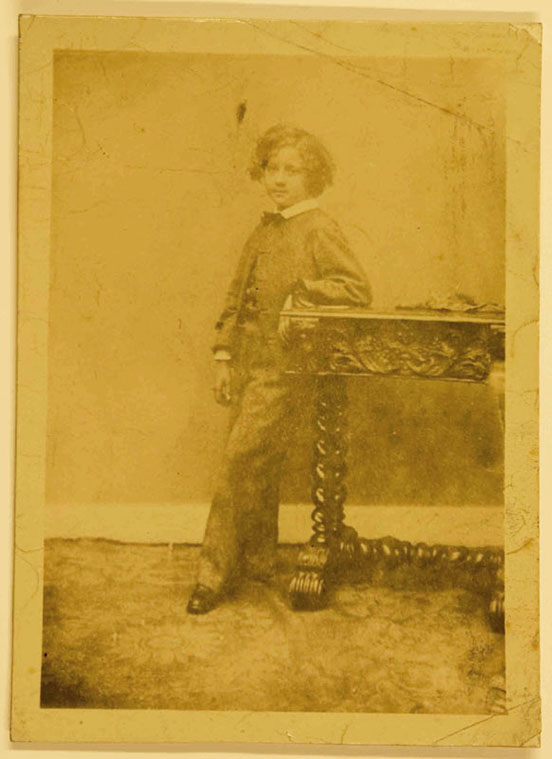 Photograph of James Whistler standing beside a carved hall table, circa 1844 (Hunterian Gallery, Glasgow)