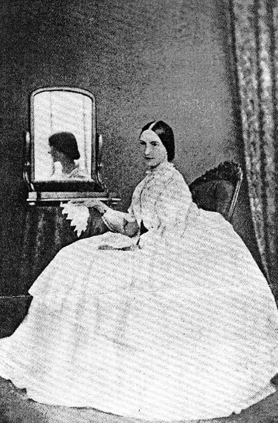 Mary Isabella McNeill Rodewald sitting in white, full-skirted dress, from the Rohdewald family archives